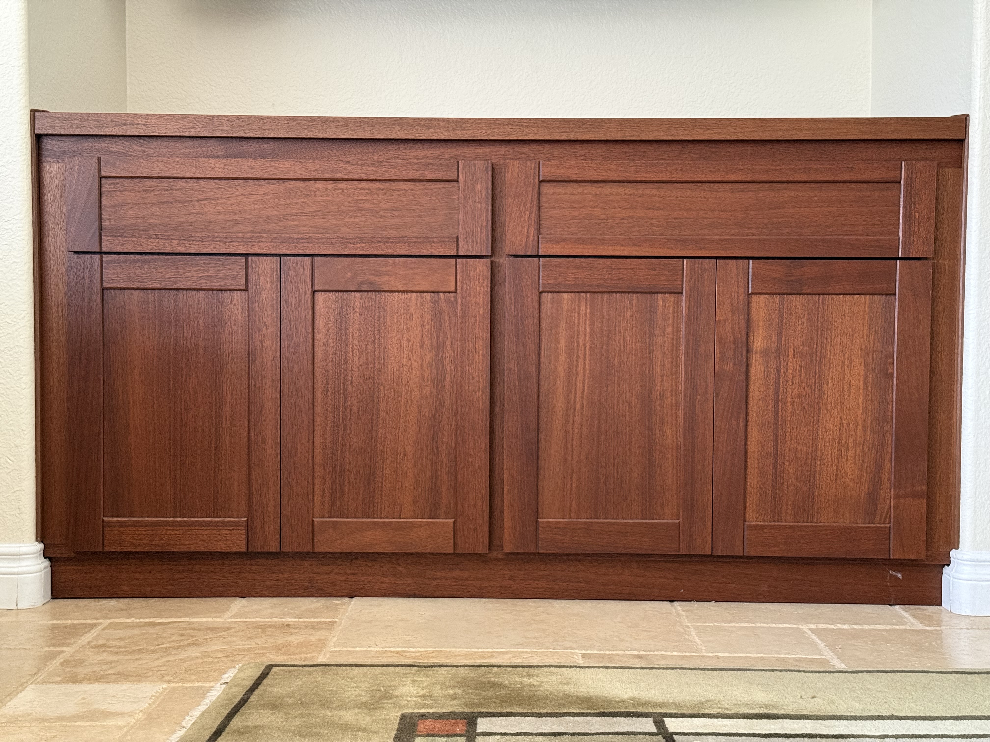 Angled detail of mahogany console shaker door panels and reveal lines