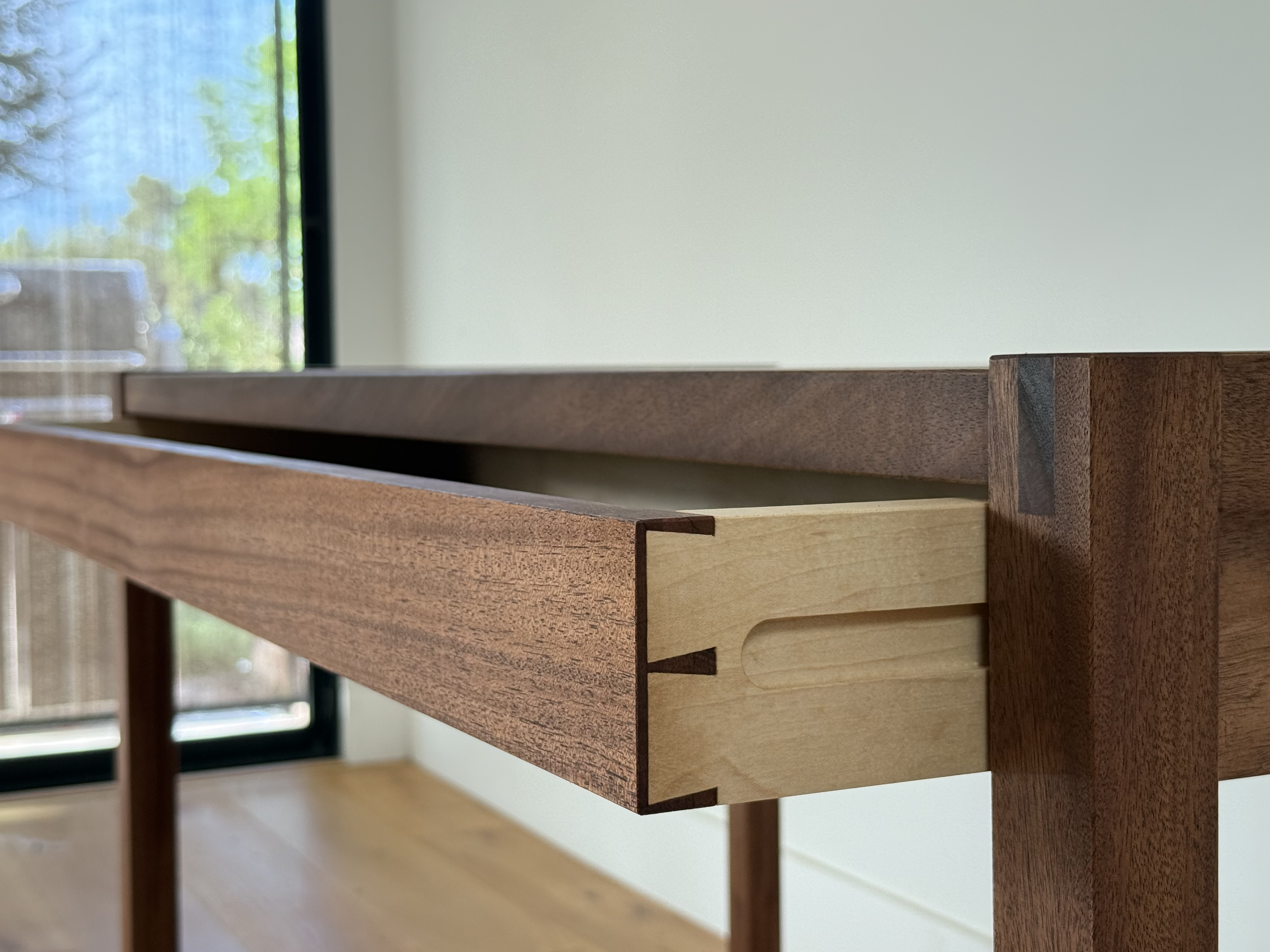 African Mahogany desk drawer partially open, hand-cut dovetail joinery detail