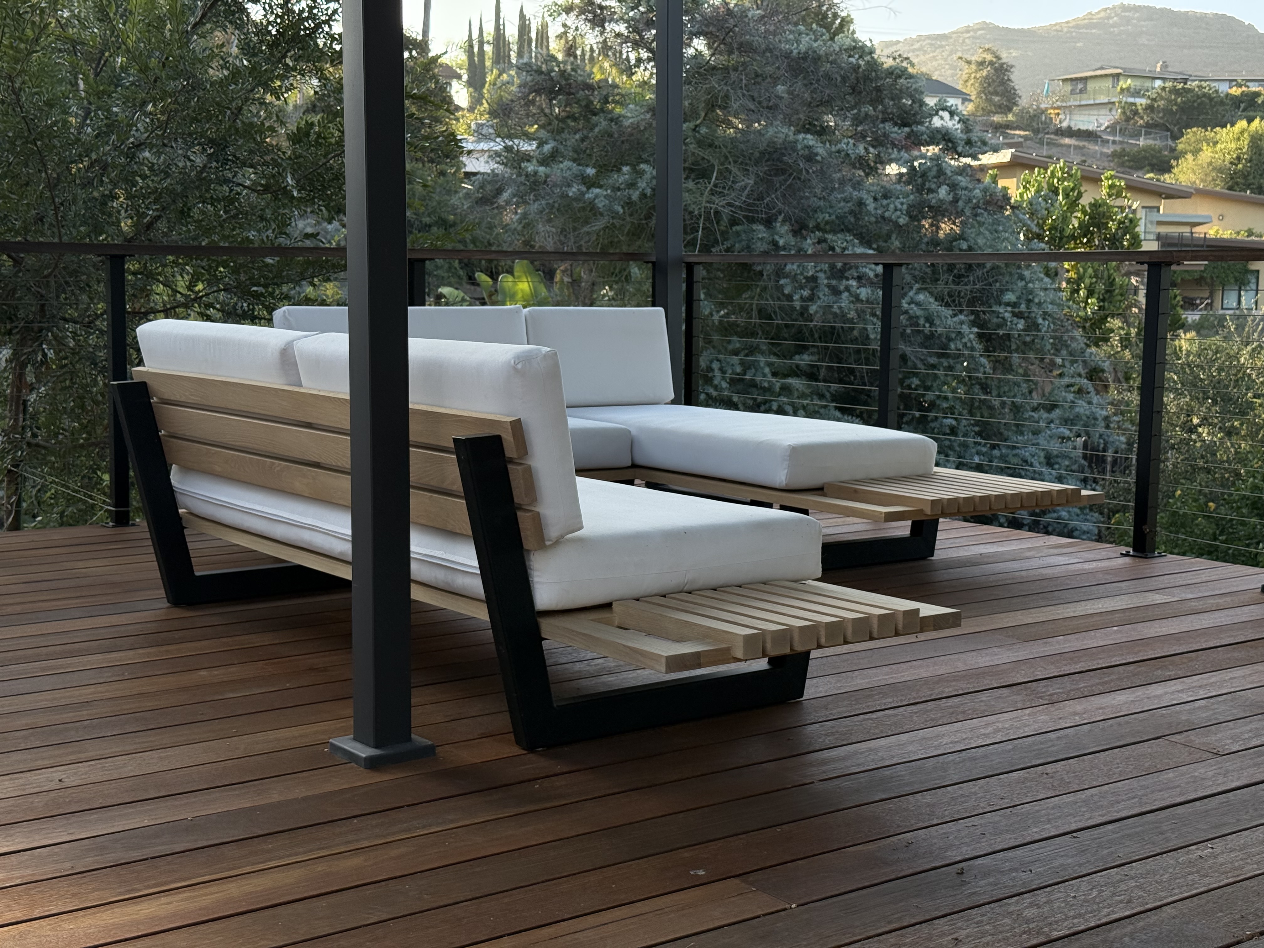 Solid hardwood-framed outdoor sectional on a North County San Diego deck, walnut slats with white cushions