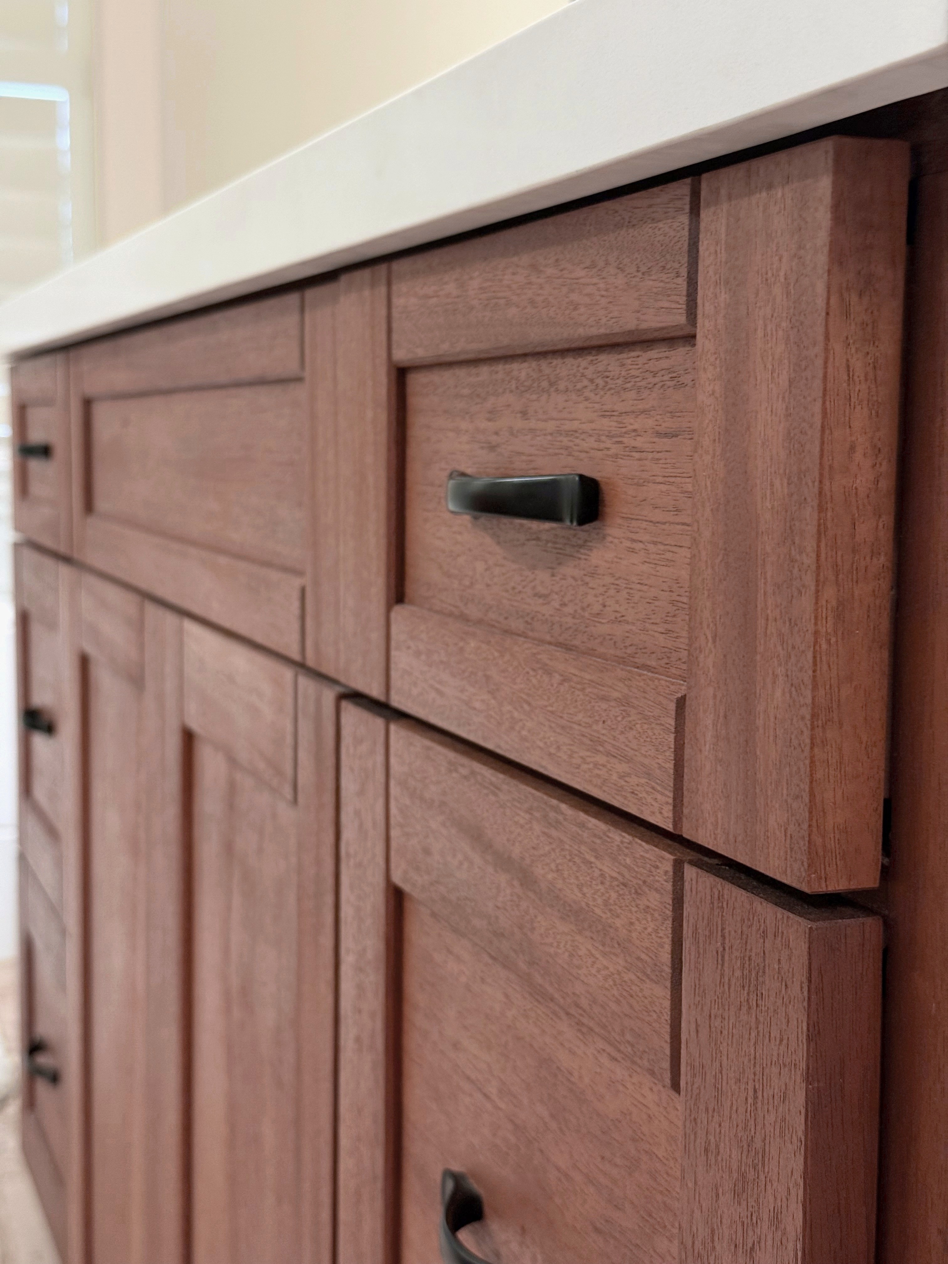 Solid mahogany bathroom vanity with shaker-style drawers and black bail hardware