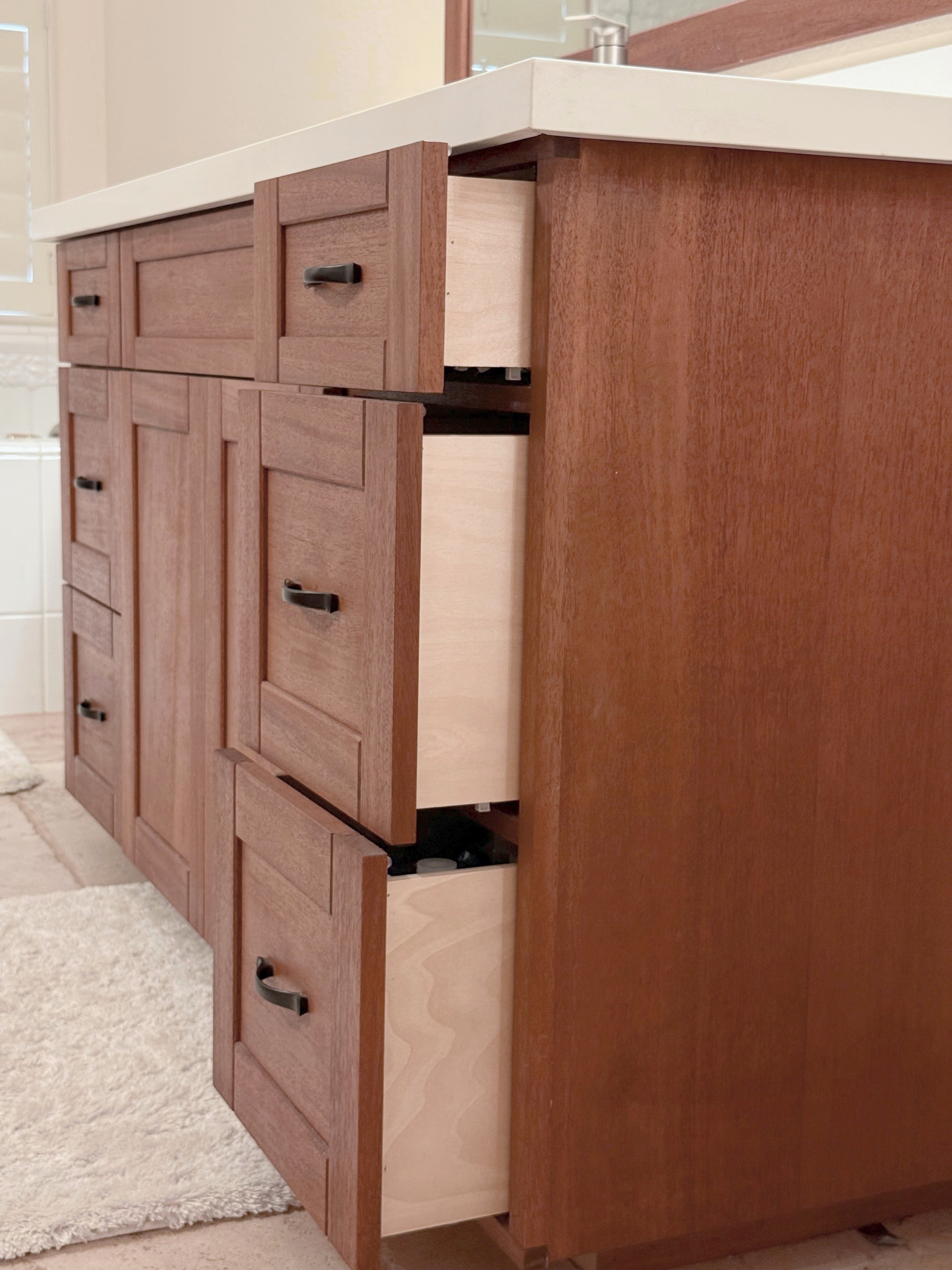 Mahogany vanity, angled detail of cabinet doors and reveal lines